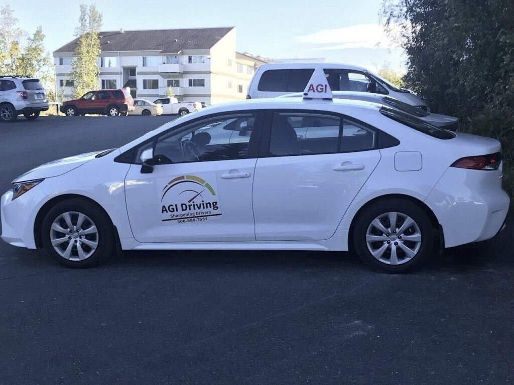 agi driving driving school car parked in lot white color