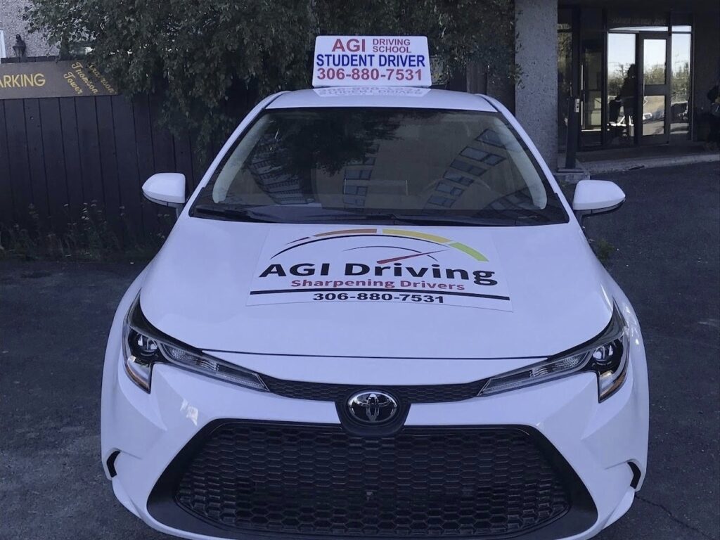 agi driving student driver vehicle with signage and contact info